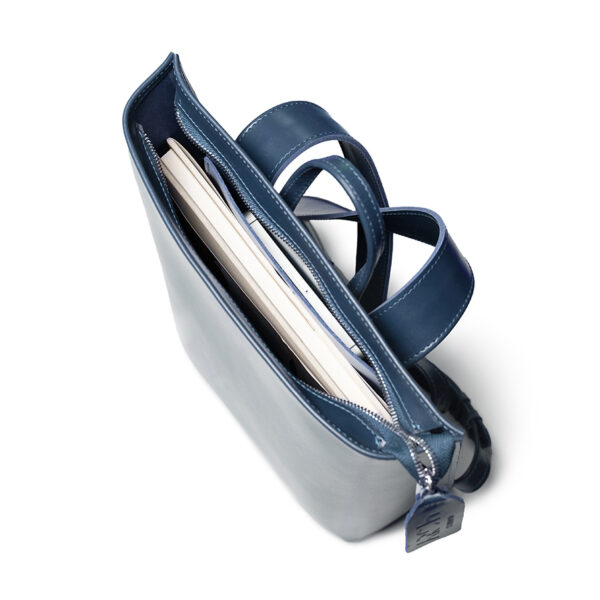 Minimalist navy leather backpack ARCH EDGE BACKPACK NAVY with a structured silhouette and adjustable straps.