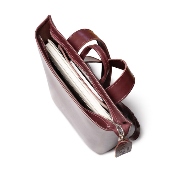Minimalist bordeaux leather backpack ARCH EDGE BACKPACK BORDEAUX with a structured silhouette and adjustable straps.